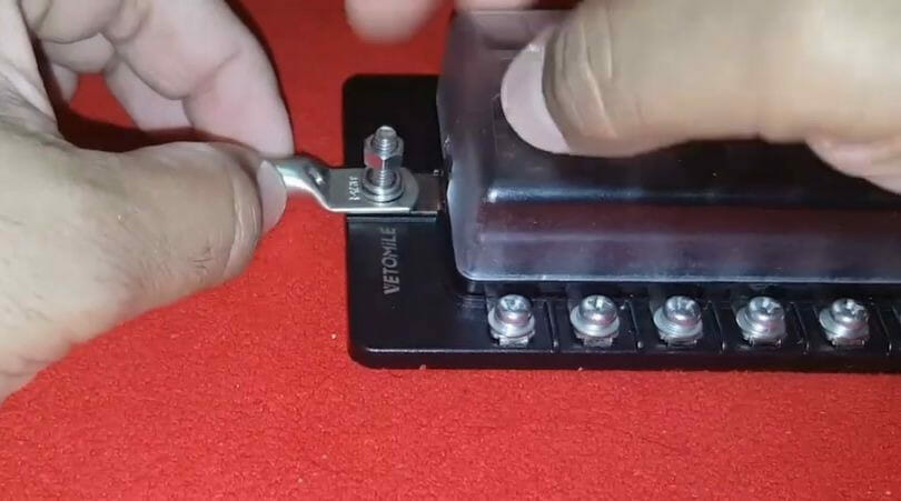 A person is using a screwdriver to open a battery box