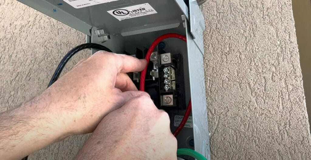 A person connecting the wire carefully in their respective spots
