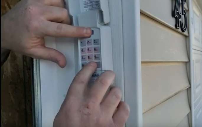 A person is using a keypad to open a door