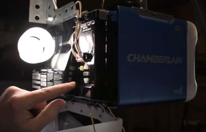 A person is putting a light on a chamberlain unit