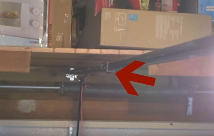 A metal rod is attached to a shelf in a garage