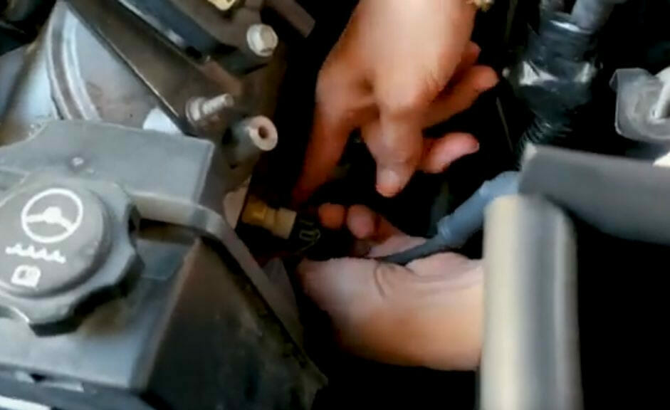 man working on the Mercedes Benz C300 engine 