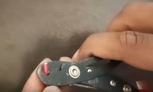insert the wire into the manual wire stripper's hole