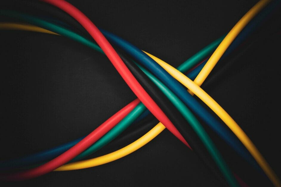 intertwined wires of different colors in a black background
