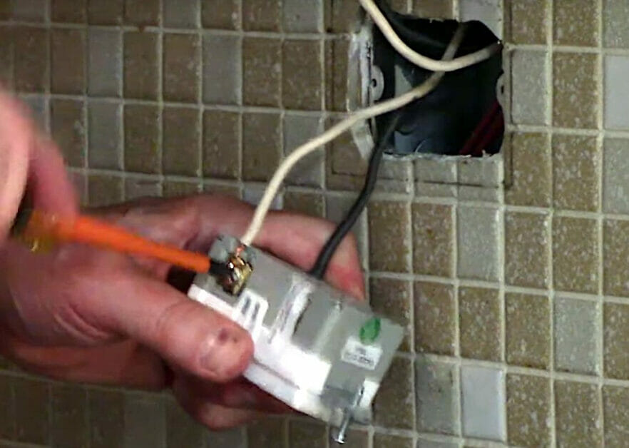 securing the wires with screw to the GFCI Outlet