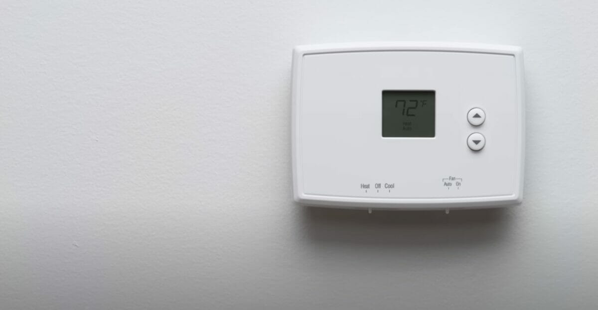 A digital thermosta on a white wall