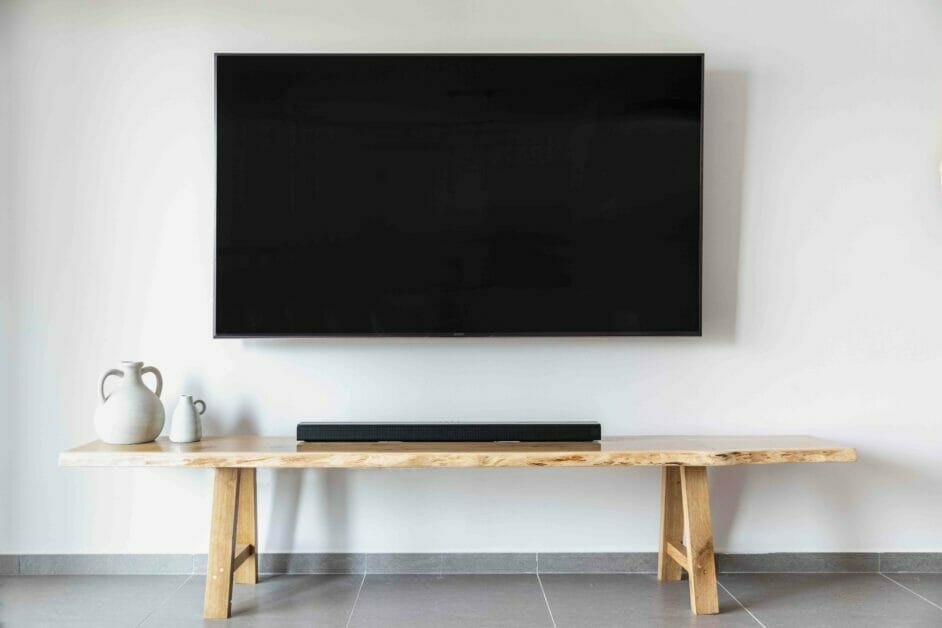 A living room setup featuring a wall-mounted TV and clever wire management.
