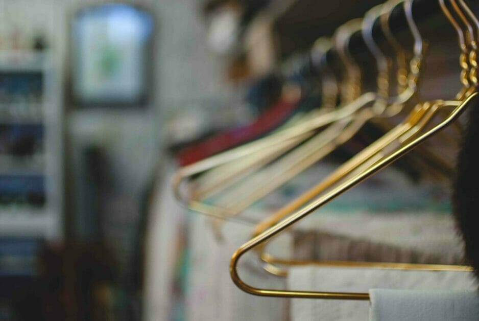 wire hangers in gold on a rack with clothes