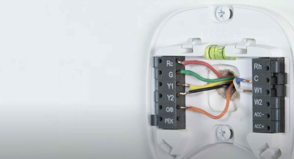 A thermostat with attached wires, including an RC wire