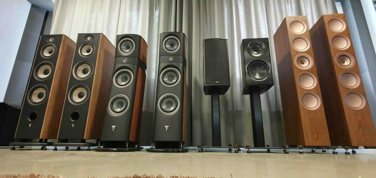 8 different speakers with different sizes displayed in a room
