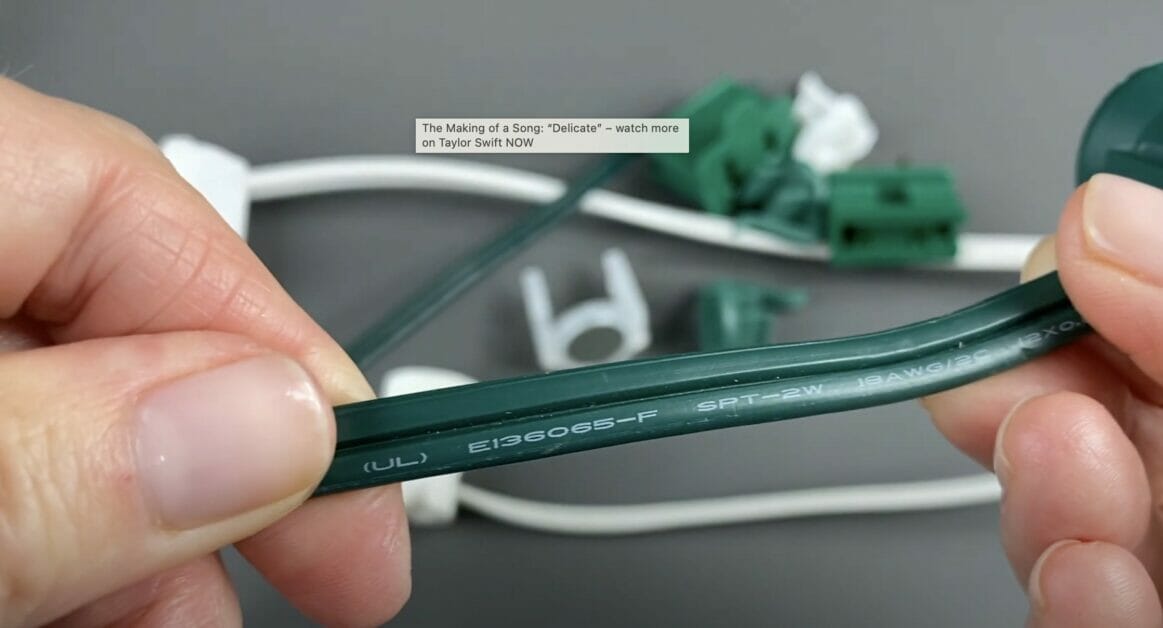 A woman's hand holding SPT2 wire in green color