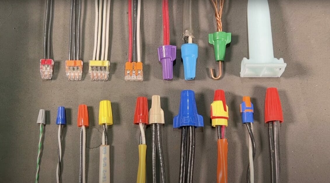A lined up wires with connectors and wire caps