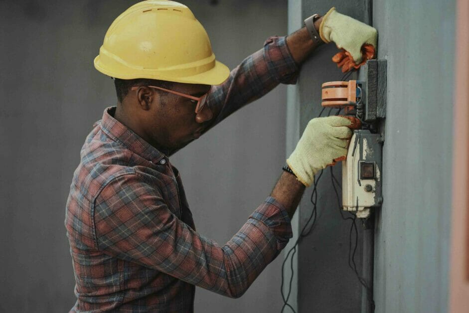 An electrician inspecting electrical switch