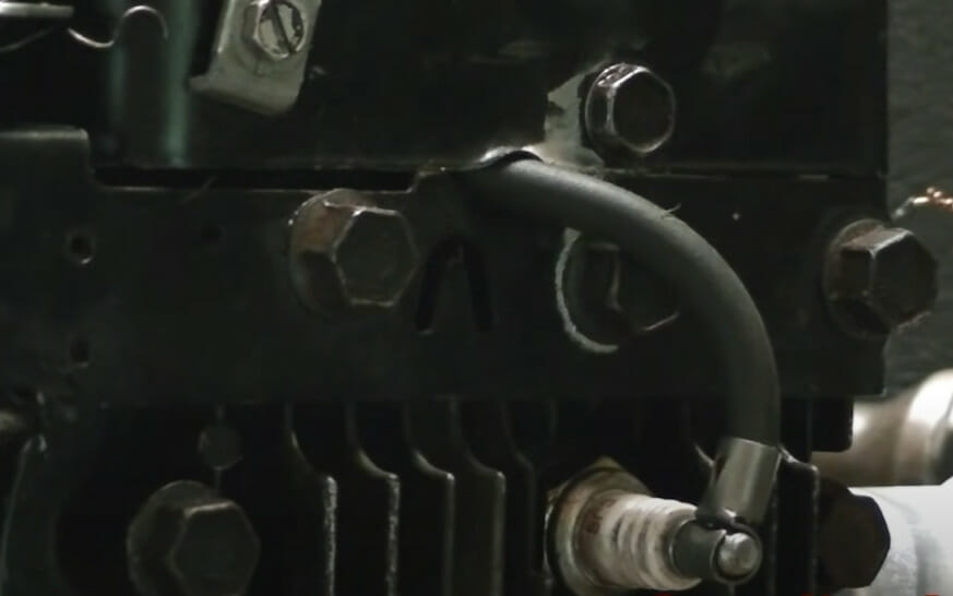 A close up look of a spark plug connected to its wire