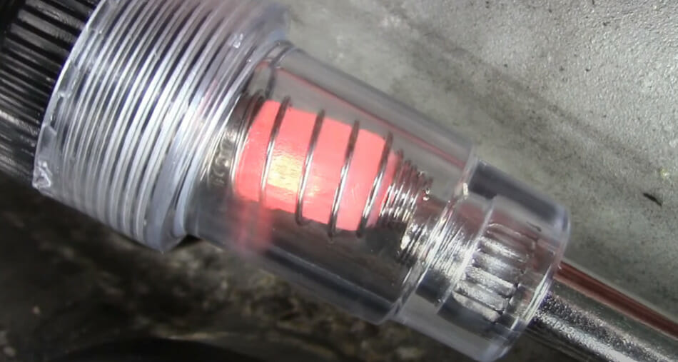 A closer look at the grounding the tester to the spark plug