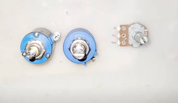 Three potentiometer on a white surface
