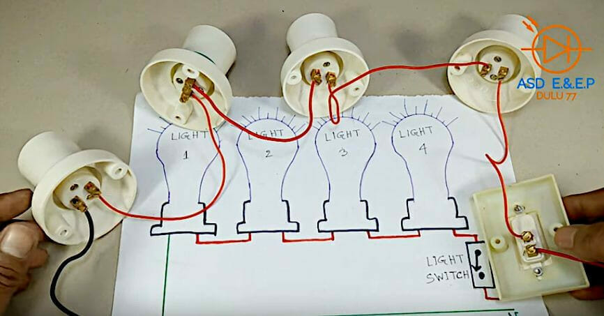 A person start wiring in a series the light bulb and switch