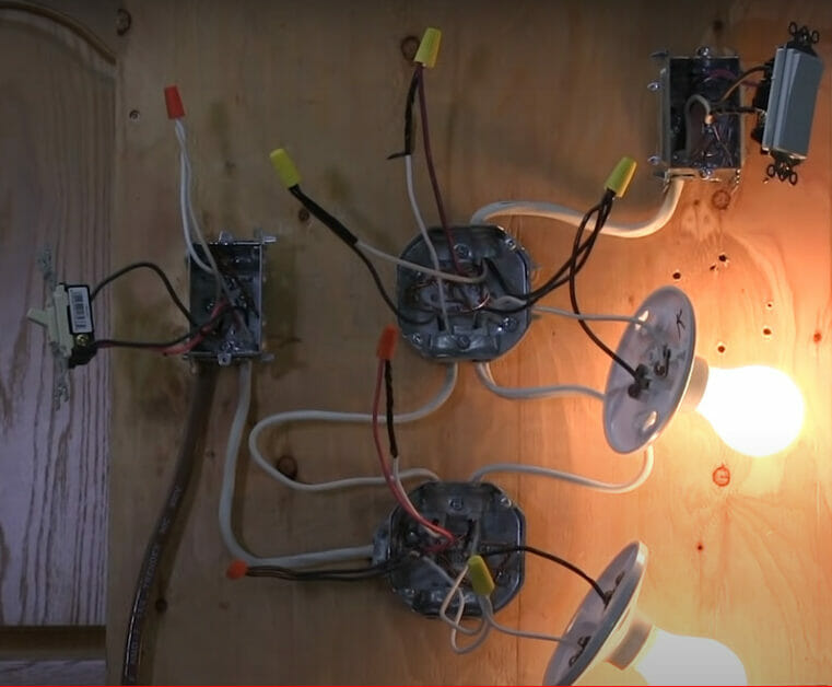 A demo of a 3-way light switch with the light bulb turned on