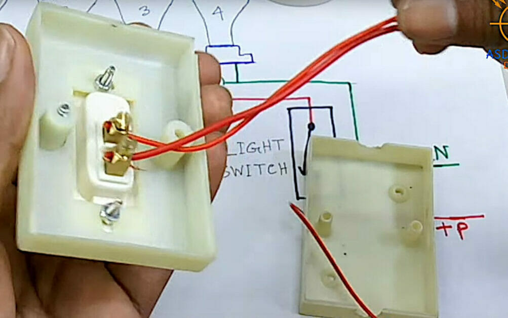 A person is wiring multiple lights to one switch