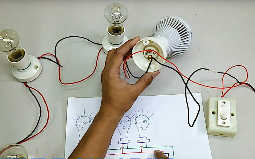 A person is working with a light bulb in a series wiring