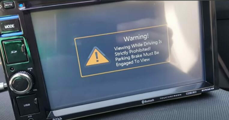 A dashboard warning message is displayed on a car