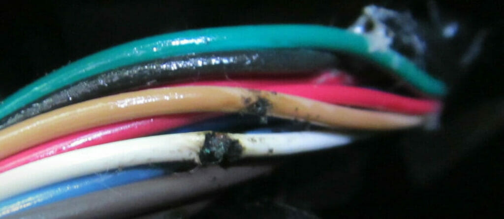 A close up of a multi-colored wire displaying potential risks when positive and negative wires make contact