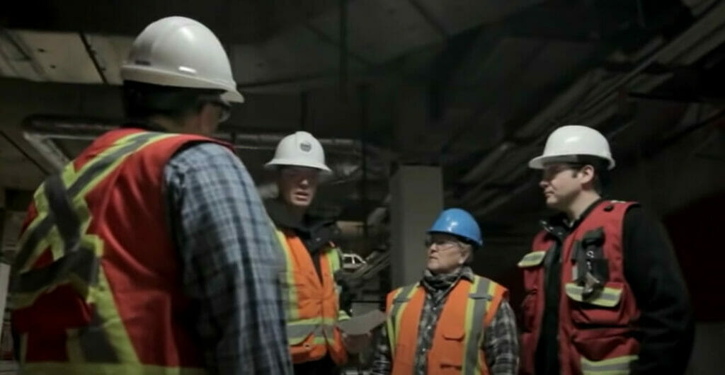A group of electrical workers with safety gears in discussion