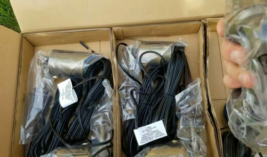 A person is unpacking wires from a box