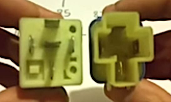 A person holding a 4 and 5-pin 12V relay