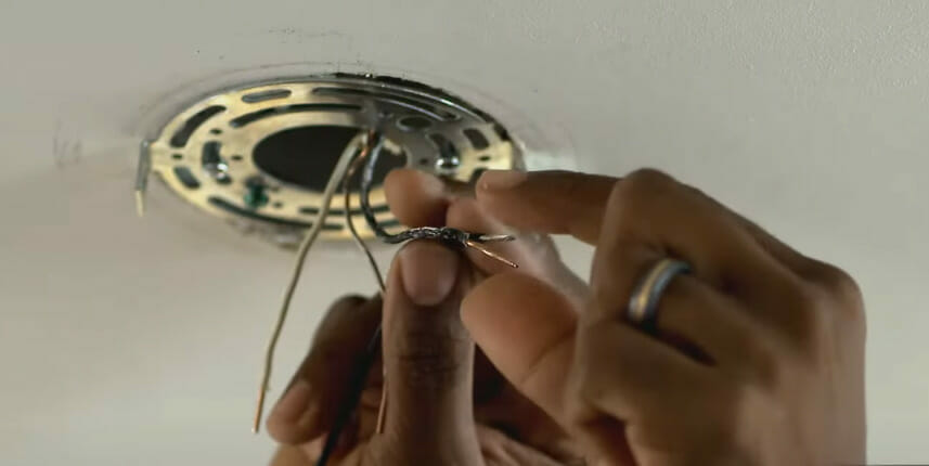 A person is installing lighting fixtures using 16 gauge wire