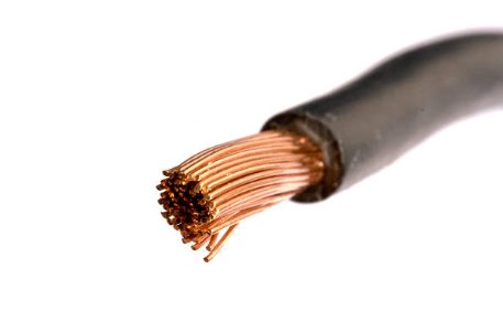 A close up of a black wire with copper wires