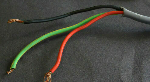 A black, green and red wires with stripped on its ends