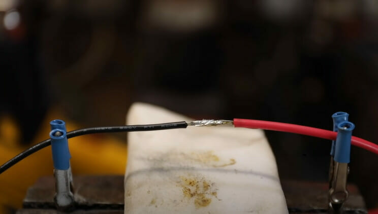 A wire is connected to a piece of metal through solder