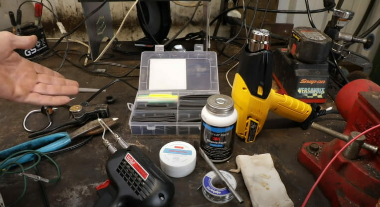 A person showing his tools for soldering