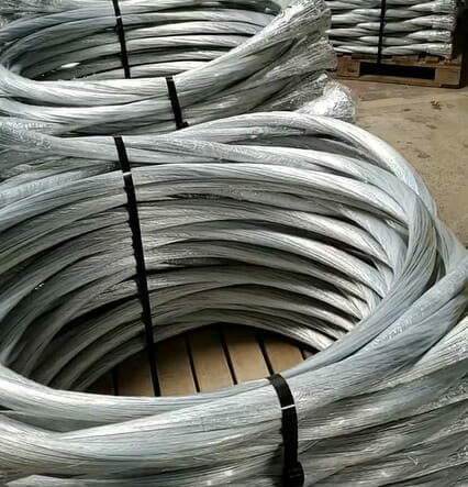 Numerous coils of galvanized wire used for baling in a warehouse