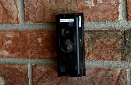 A video doorbell installed at the stone wall