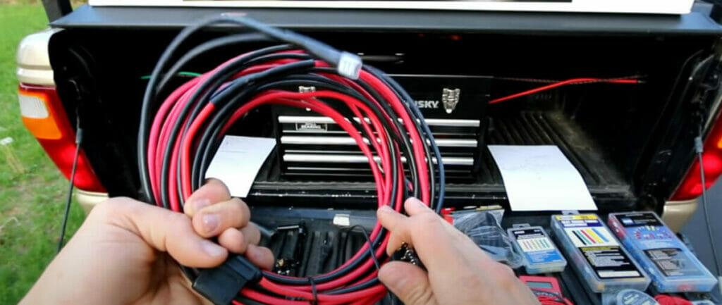 A person holding rocker switch wires