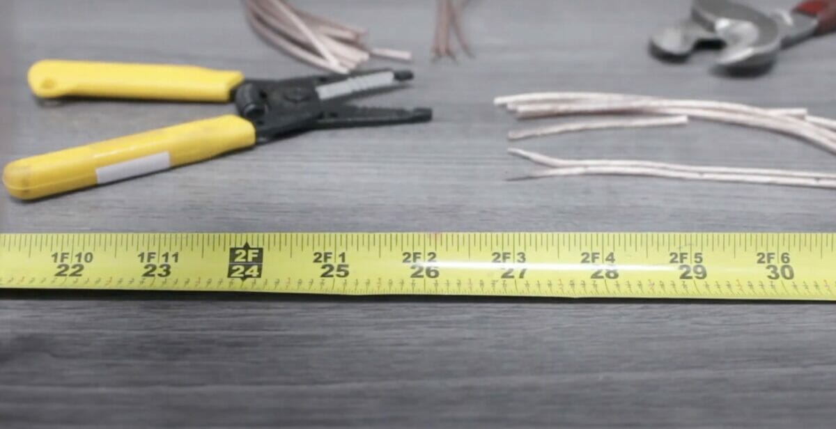 Tools for cutting wires on the table: tape measure, cutter/stripper, cut wires