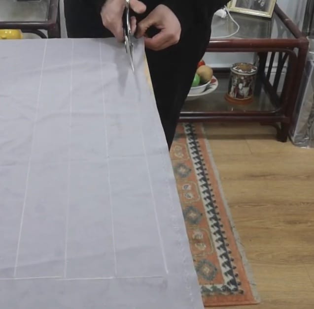 A person doing the continuous cutting technique on a fabric