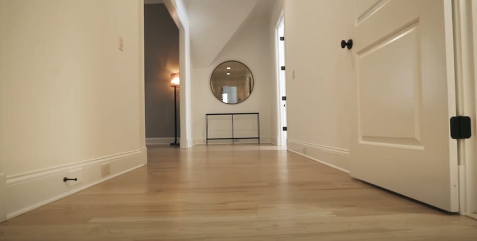 A woold floor in a cream wall paint and doors