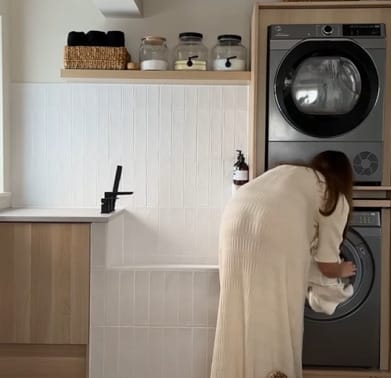 A woman doing the laundry in the laundry room