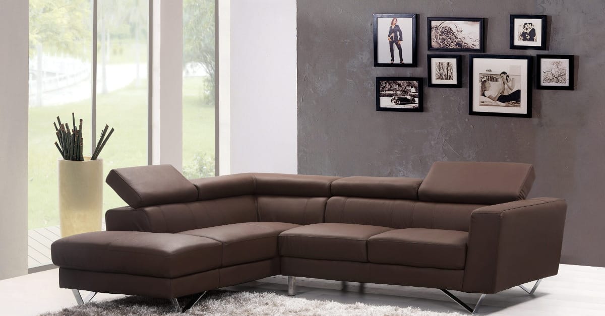 A comfortable brown leather sectional sofa is the focal point of a stylish living room