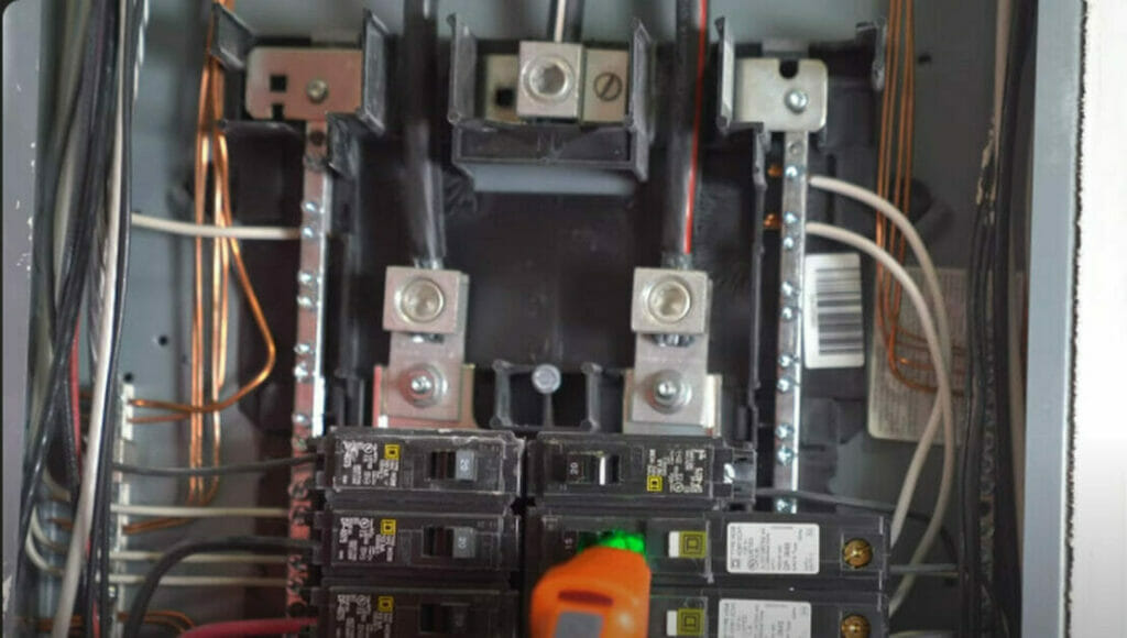 A circuit breaker box with wires attached to it