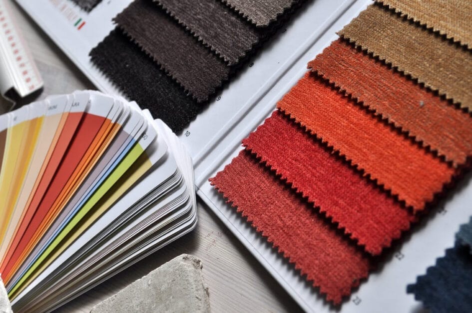 A collection of color swatches on a table for choosing the right fabric
