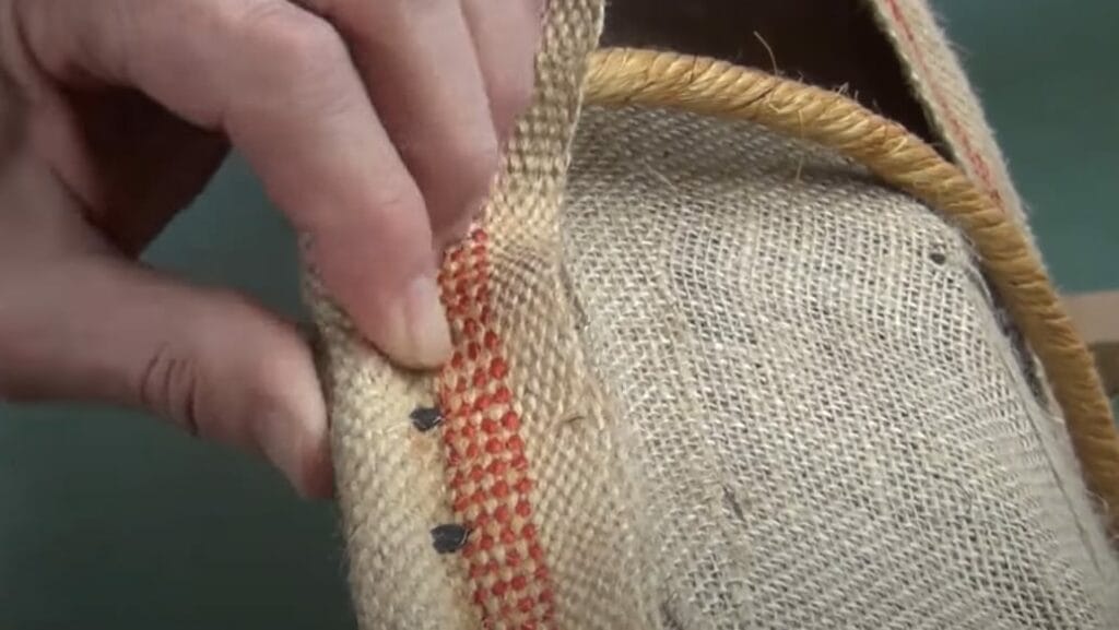 A person making a burlap /horsehair cushion