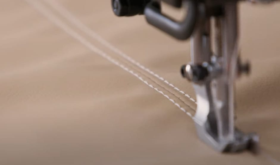 A close up of a sewing machine on a piece of fabric