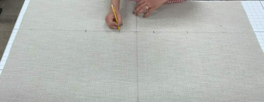 A woman marking the area for tufting process in upholstery