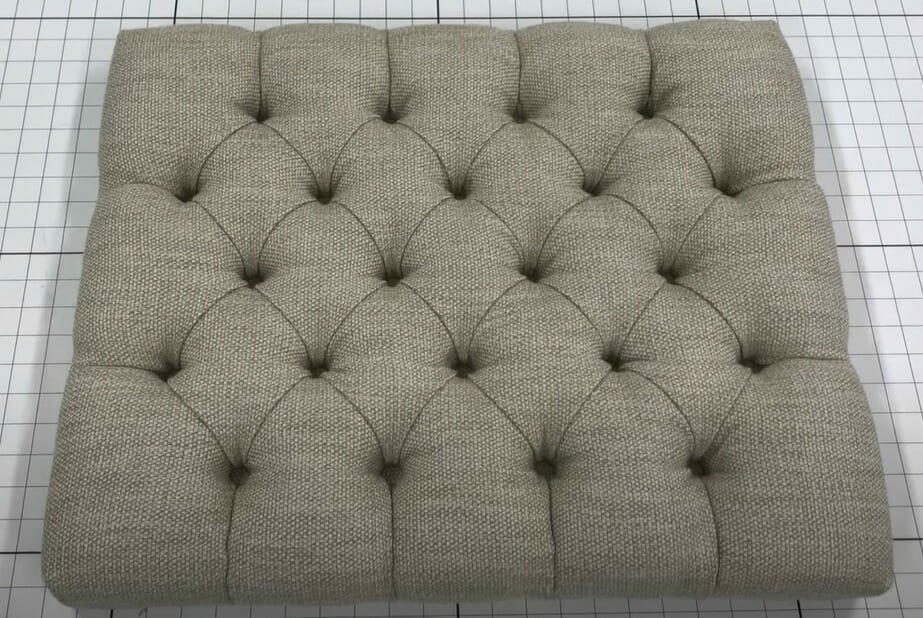 A tufted cushion in upholstery