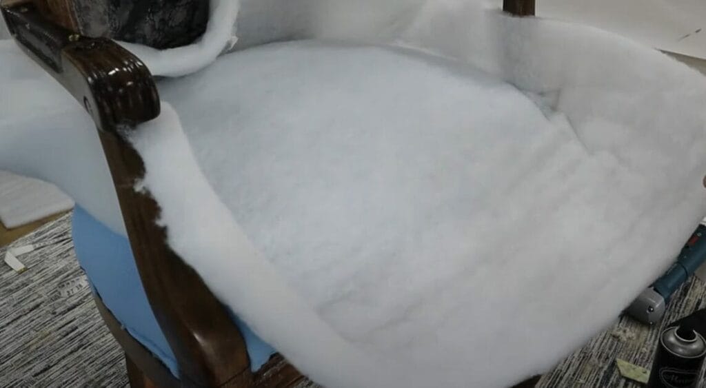 A foam is being put on a chair for upholstery