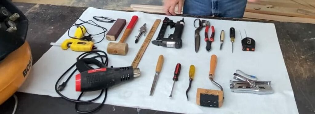 A man is laying out tools for simple projects like upholstering a cushion